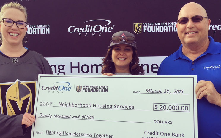 Individuals holding a giant check during a photo op