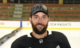 Deryk Engelland holding a set of Vegas Golden Knight credit cards from Credit One Bank